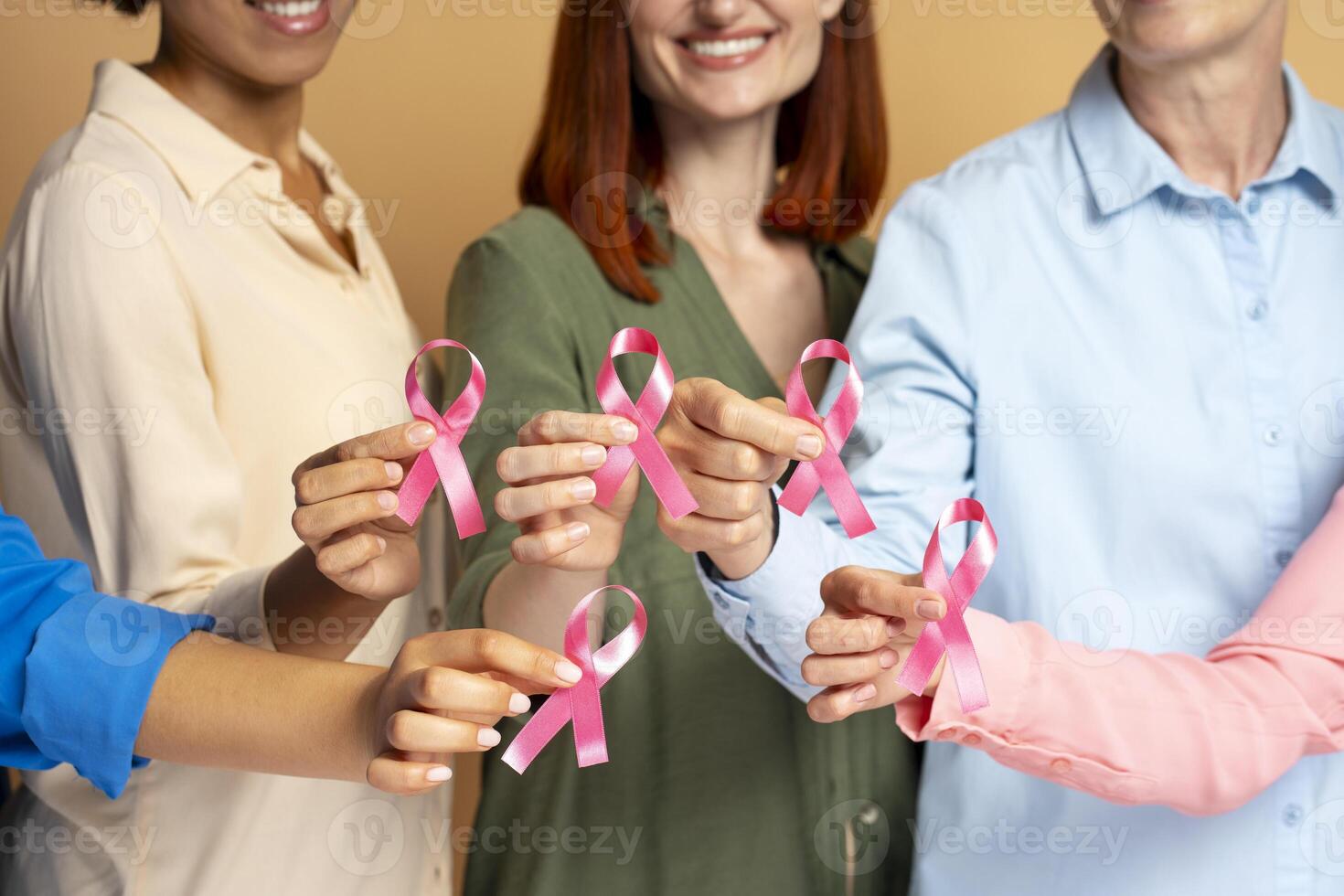 Diverse group of women holding pink ribbons for breast cancer awareness photo