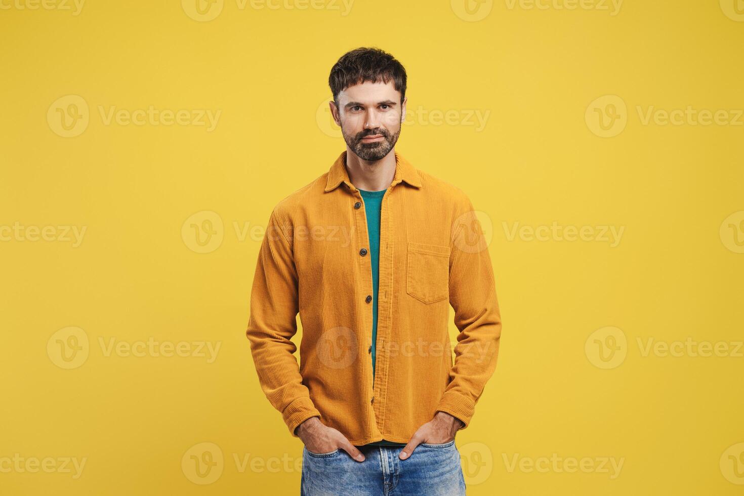 Confident, happy, bearded Hispanic man wearing stylish casual clothes, hands in pocket photo