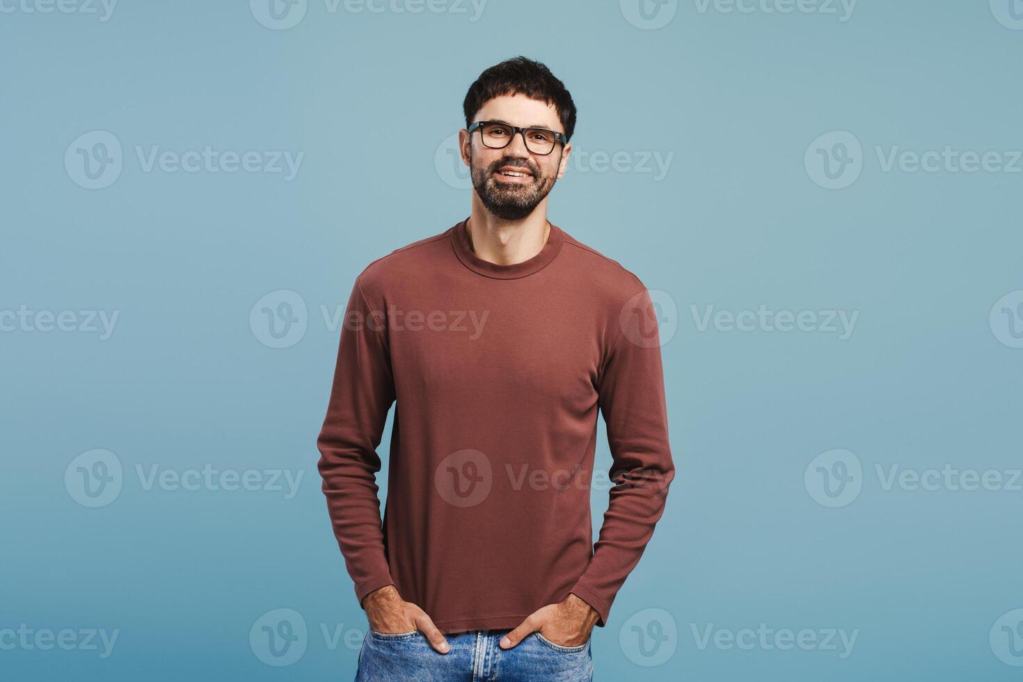 Handsome, attractive man wearing stylish eyeglasses and sweater with hands pocket photo