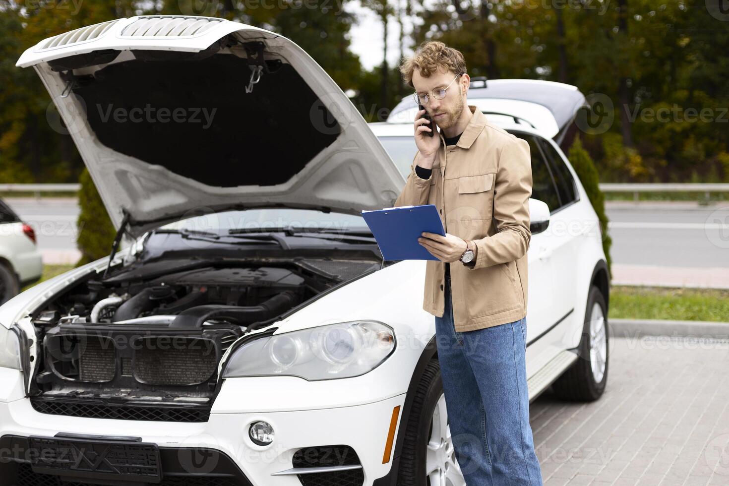 Worried driver calling mechanic describing car problem on a country road photo