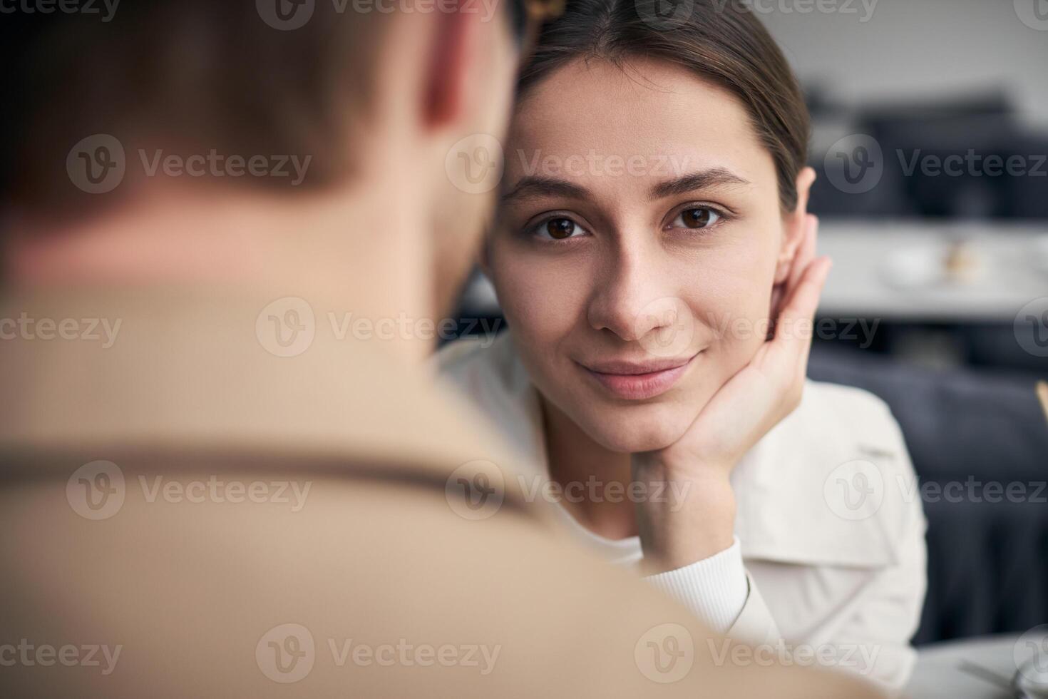 Beautiful woman smiling during romantic date in restaurant photo