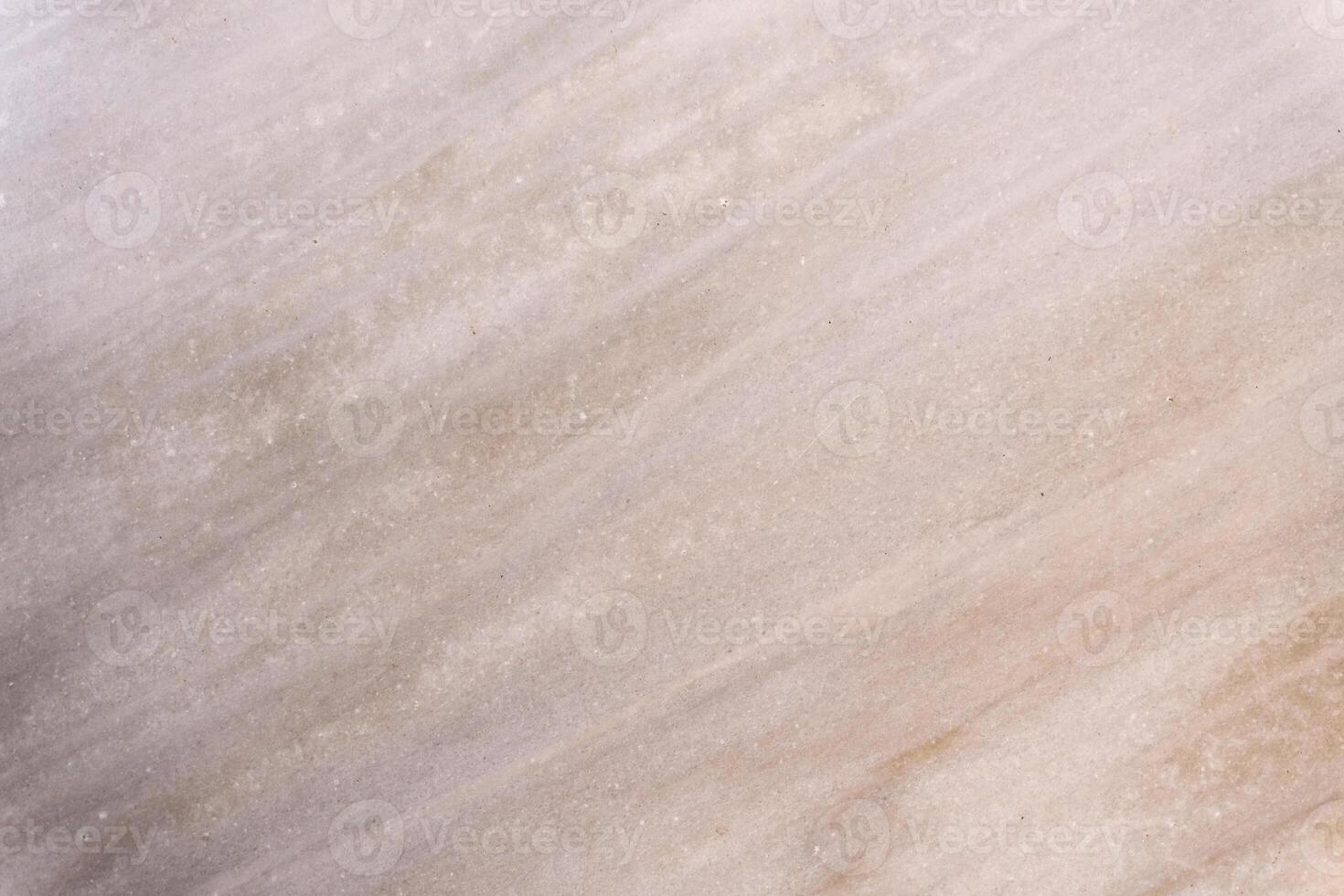 Light beige marble stone surface with diagonal veins showing natural pattern photo