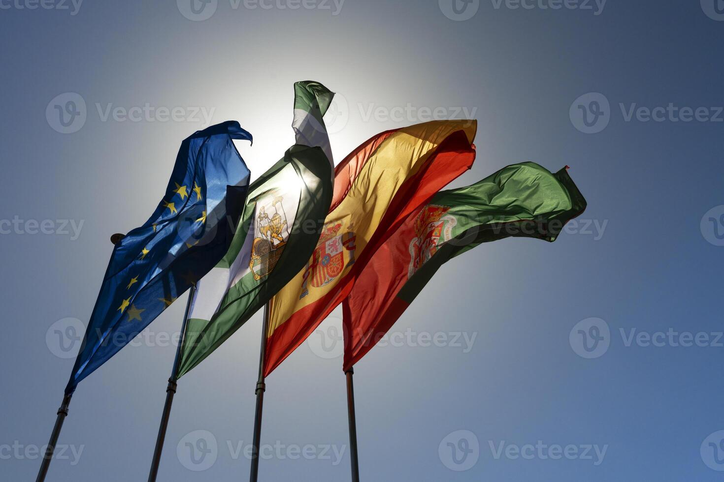 Four flags waving in the wind on a sunny day photo