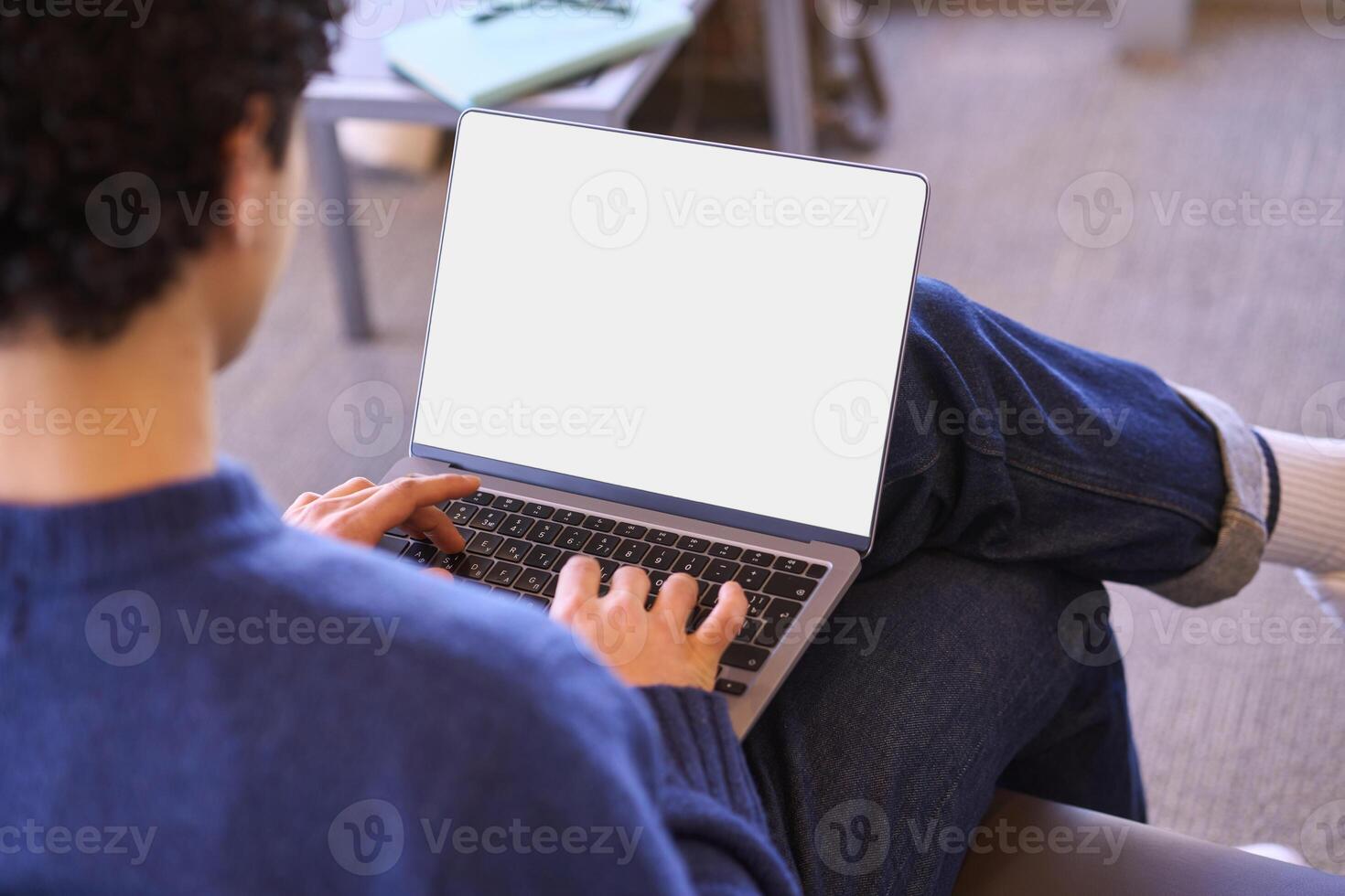 Man working on laptop with blank screen at home office photo