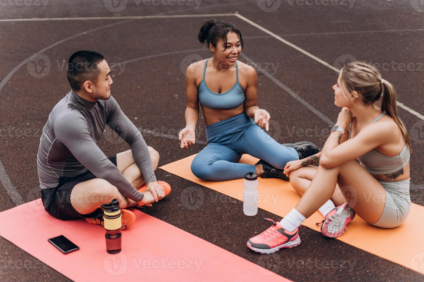 Happy, multiracial people relaxing on the street, outdoors. Young athlete training on the street photo