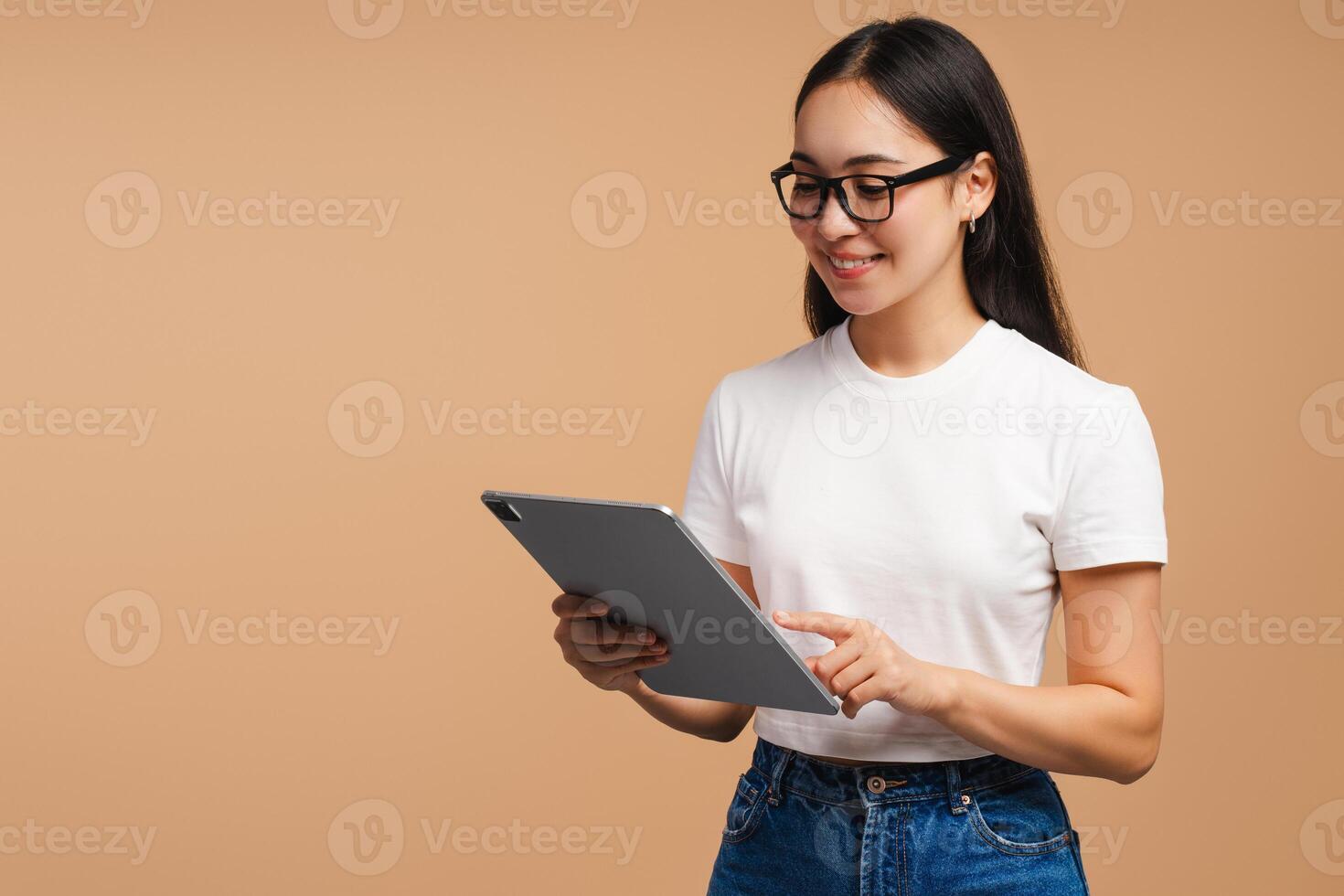 Smiling Asian woman browsing internet on digital tablet online technology and lifestyle concept photo