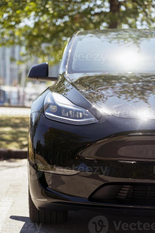 Modern black electric car parked in the city photo