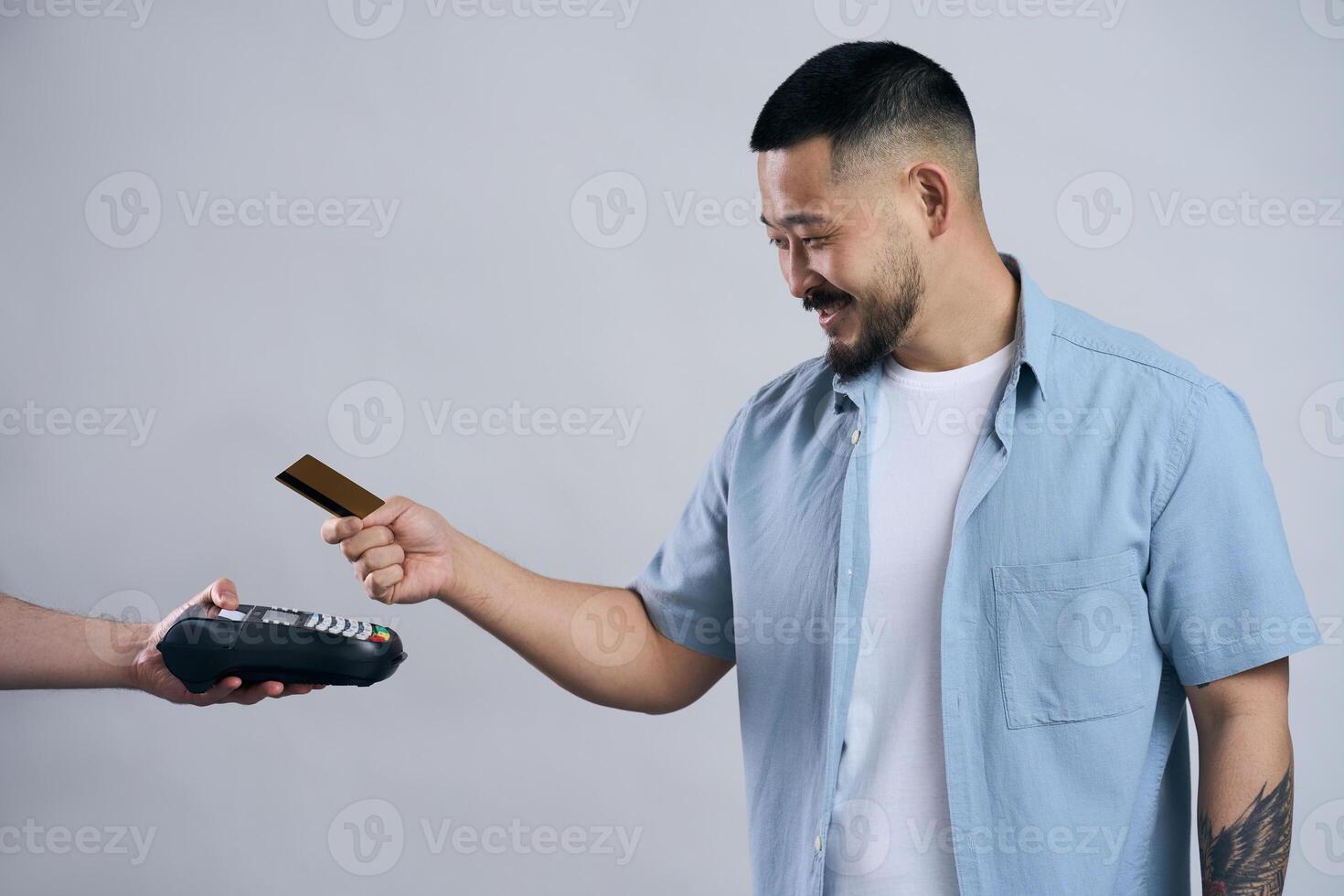 Happy customer making a payment using a credit card and a pos terminal photo