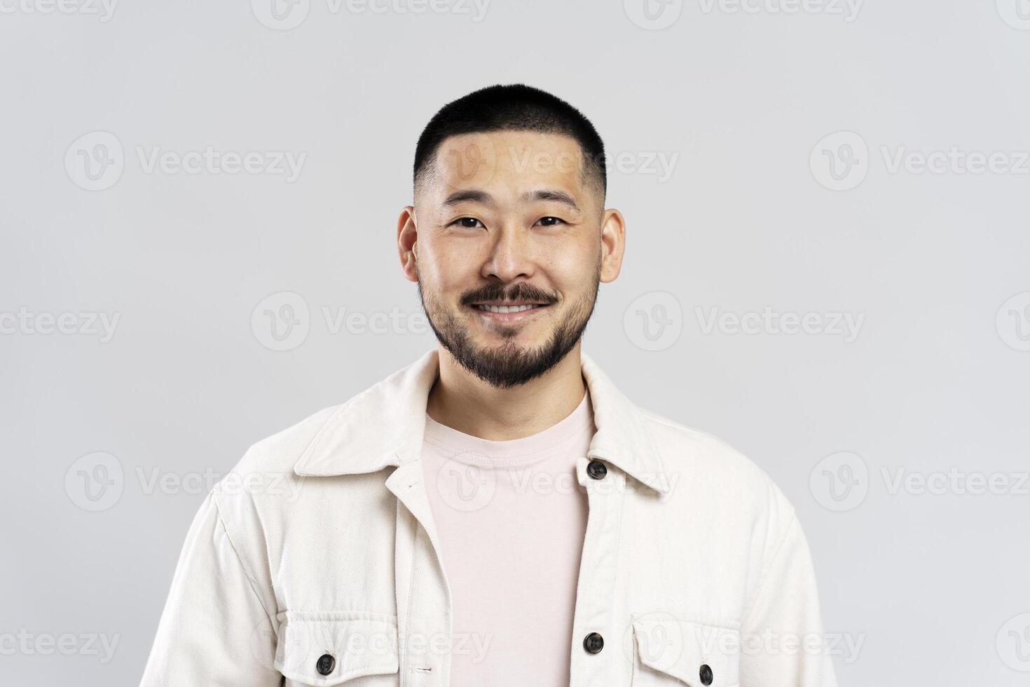 Happy young asian man smiling on white background photo