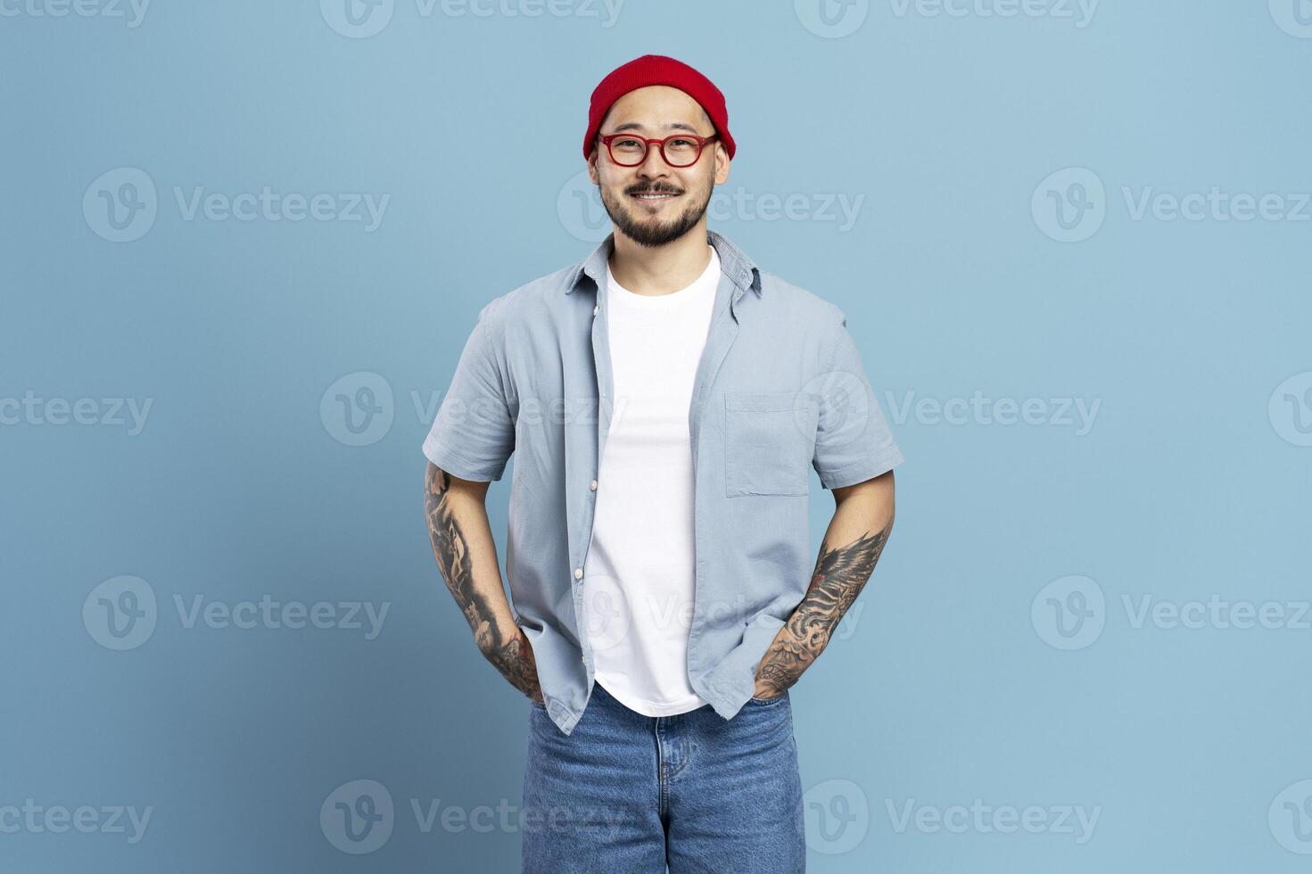 Young content designer smiling with hands in pockets photo