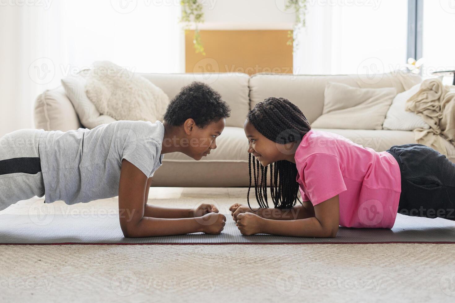 Two kids having fun while planking at home photo