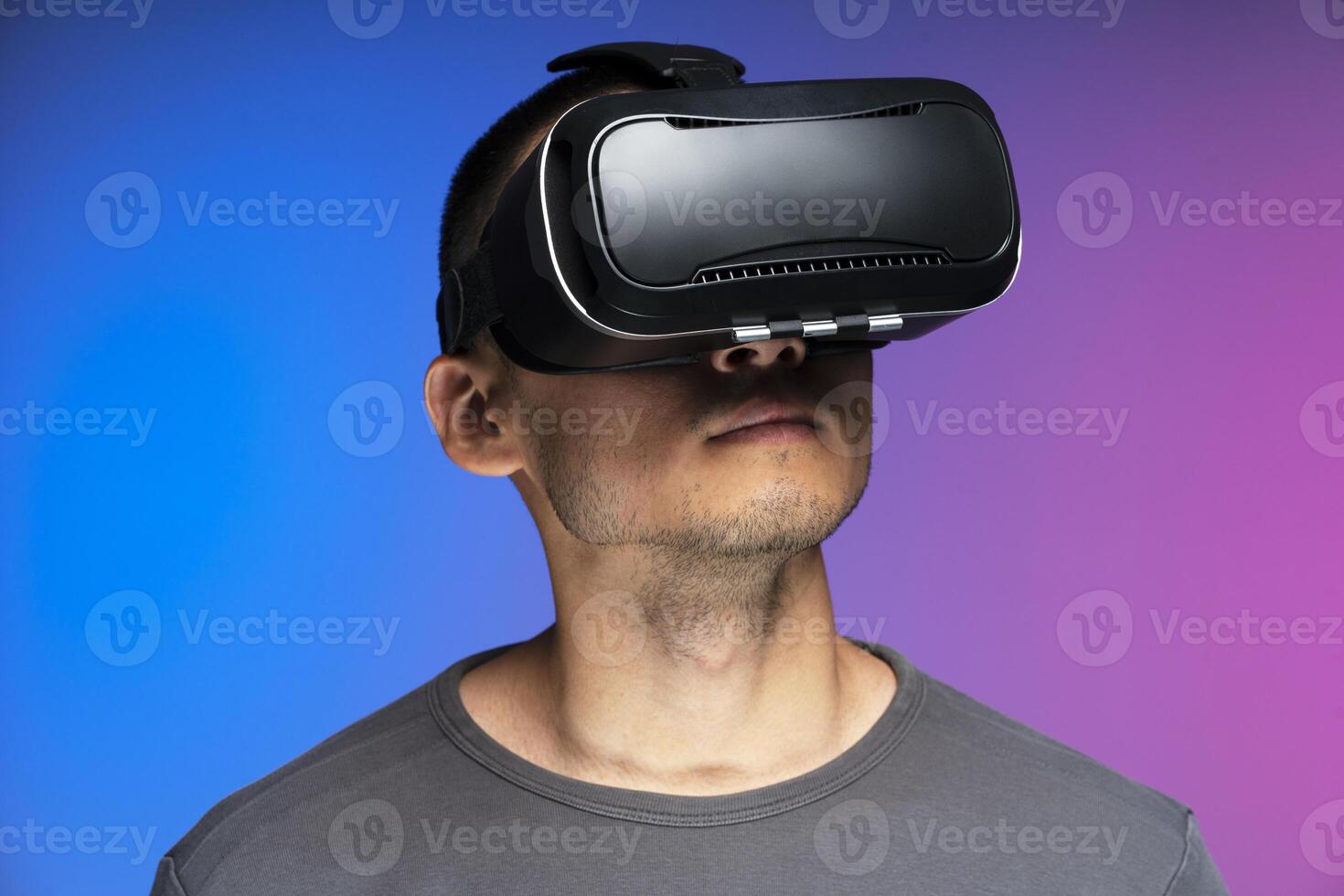 Man using virtual reality headset experiencing metaverse photo