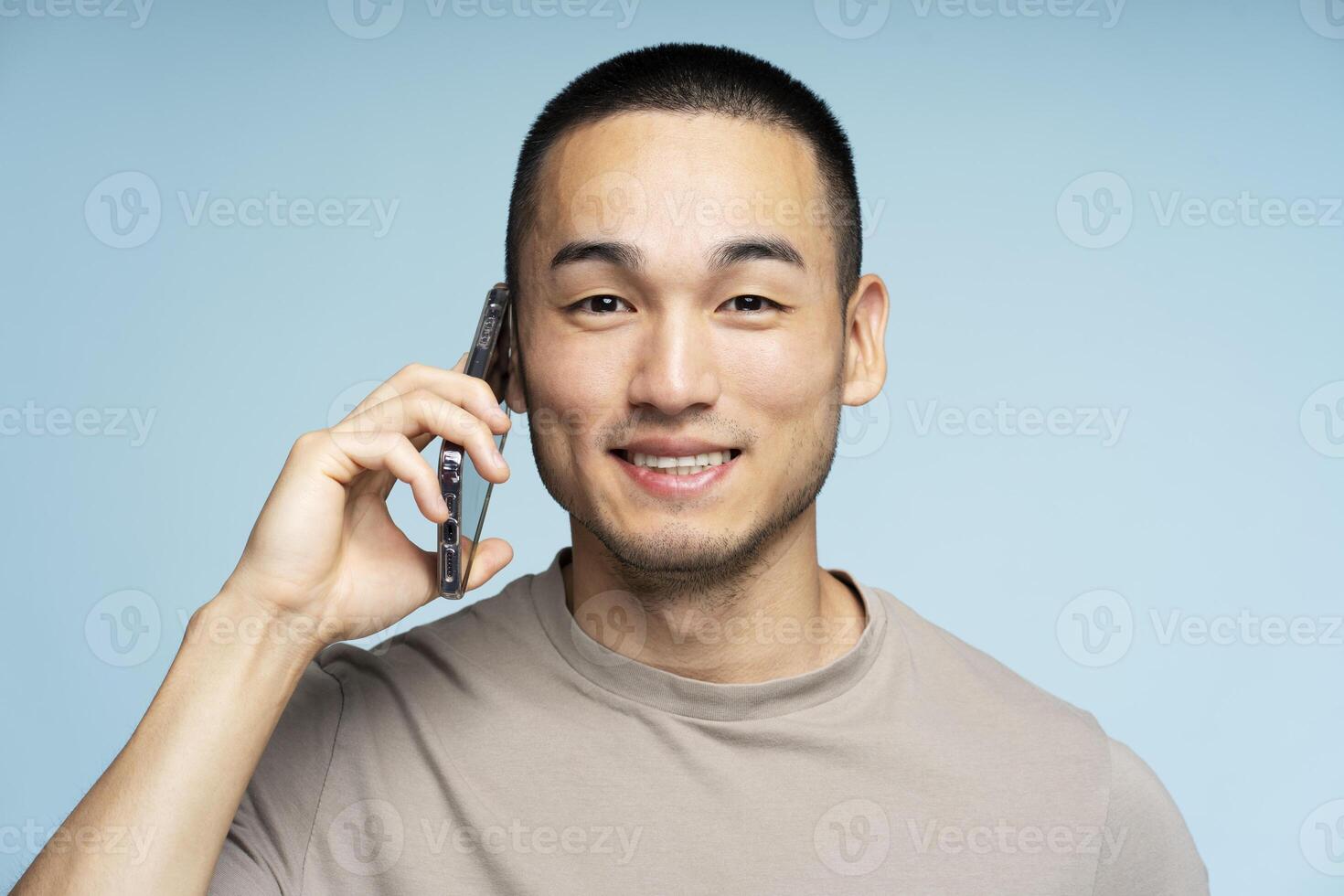 Young man smiling while talking on the phone photo