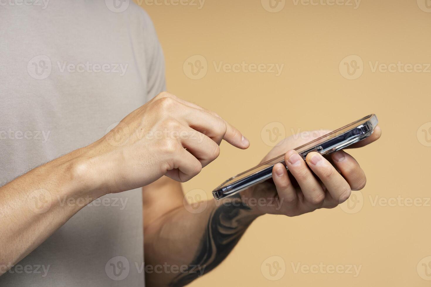 Man browsing internet on smartphone with tattooed arm photo