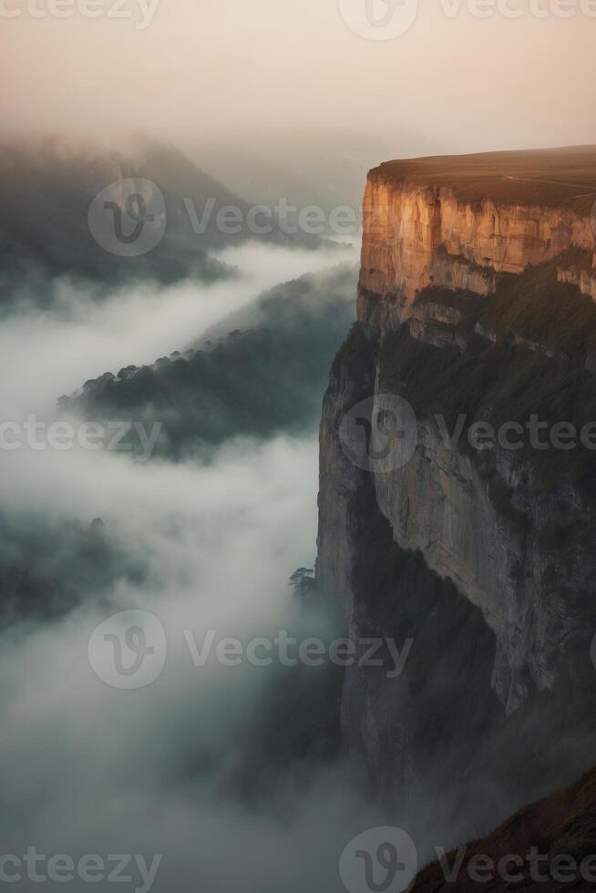 A view of a cliff with fog and clouds photo