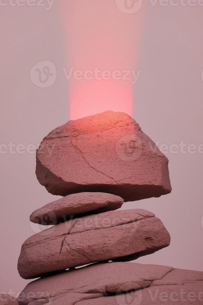A stack of rocks with a red light shining on top photo