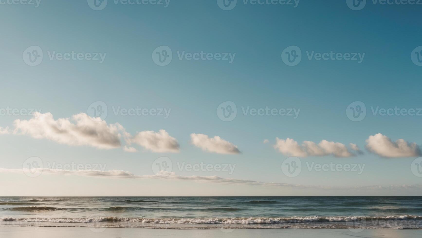 A man is standing on the beach with a surfboard photo