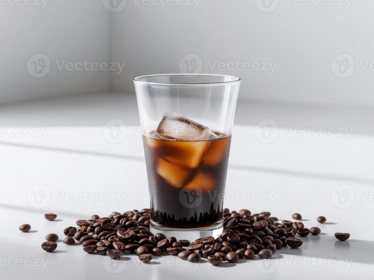A glass of iced coffee with ice and coffee beans photo
