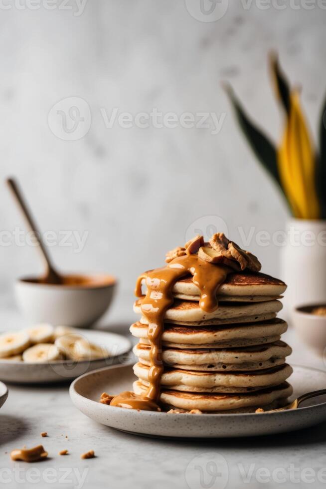 Stack of pancakes with peanut butter and banana slices photo