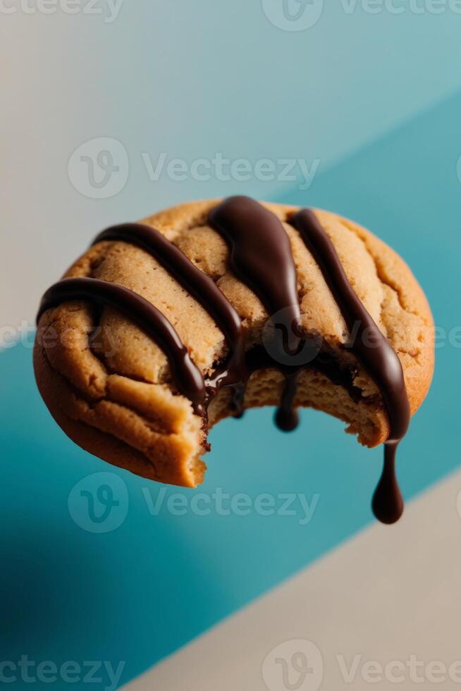 A chocolate cookie with a drizzle of chocolate on top photo