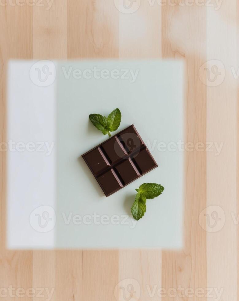 A piece of chocolate on a wooden table photo