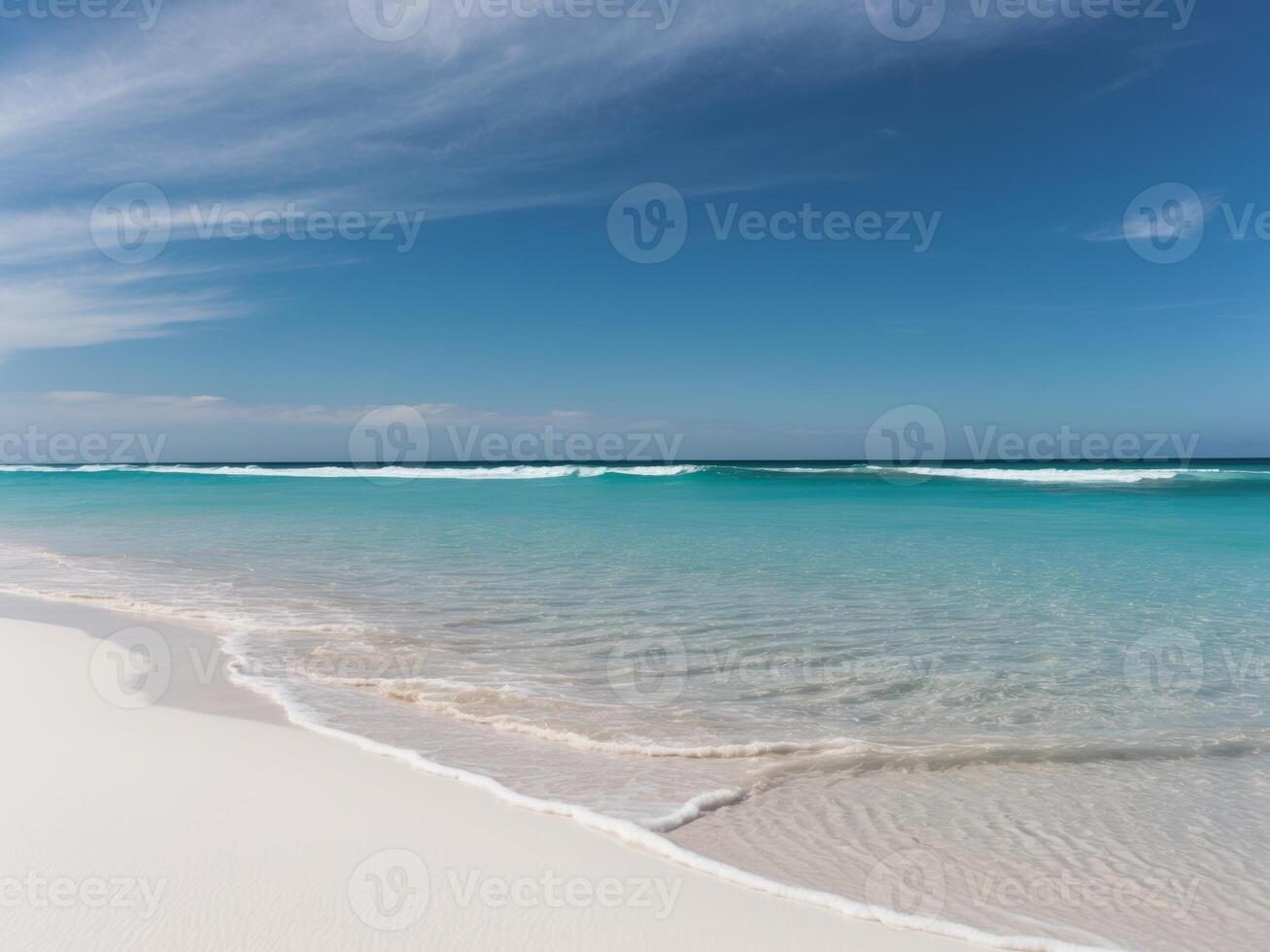 A sandy beach with waves and a blue sky photo