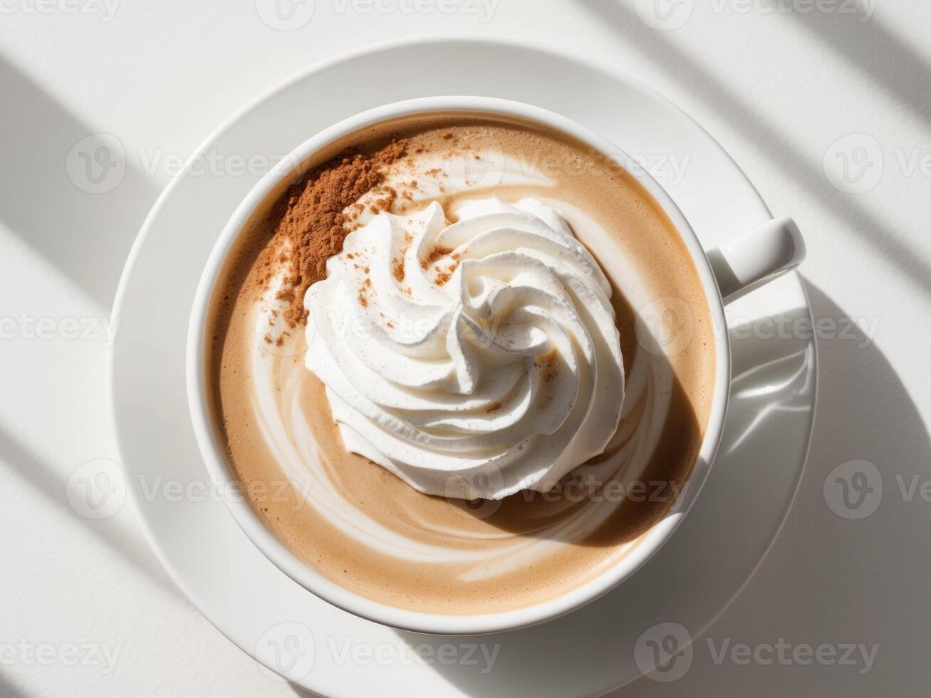 A cup of coffee with whipped cream and cinnamon photo
