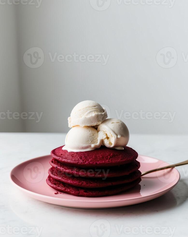 A stack of red velvet pancakes with ice cream photo