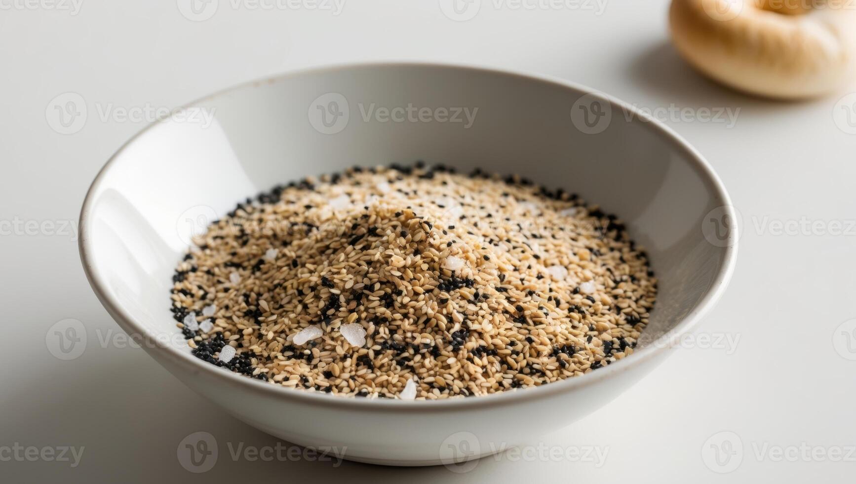 A bowl of sesame seeds and a garlic clove photo