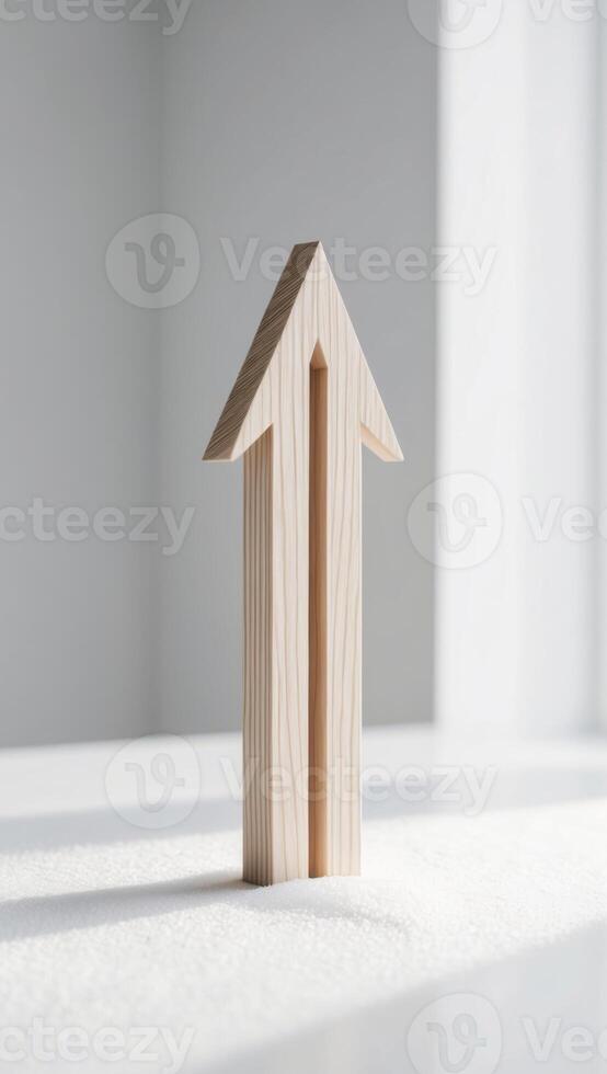 A wooden arrow is standing on a table photo