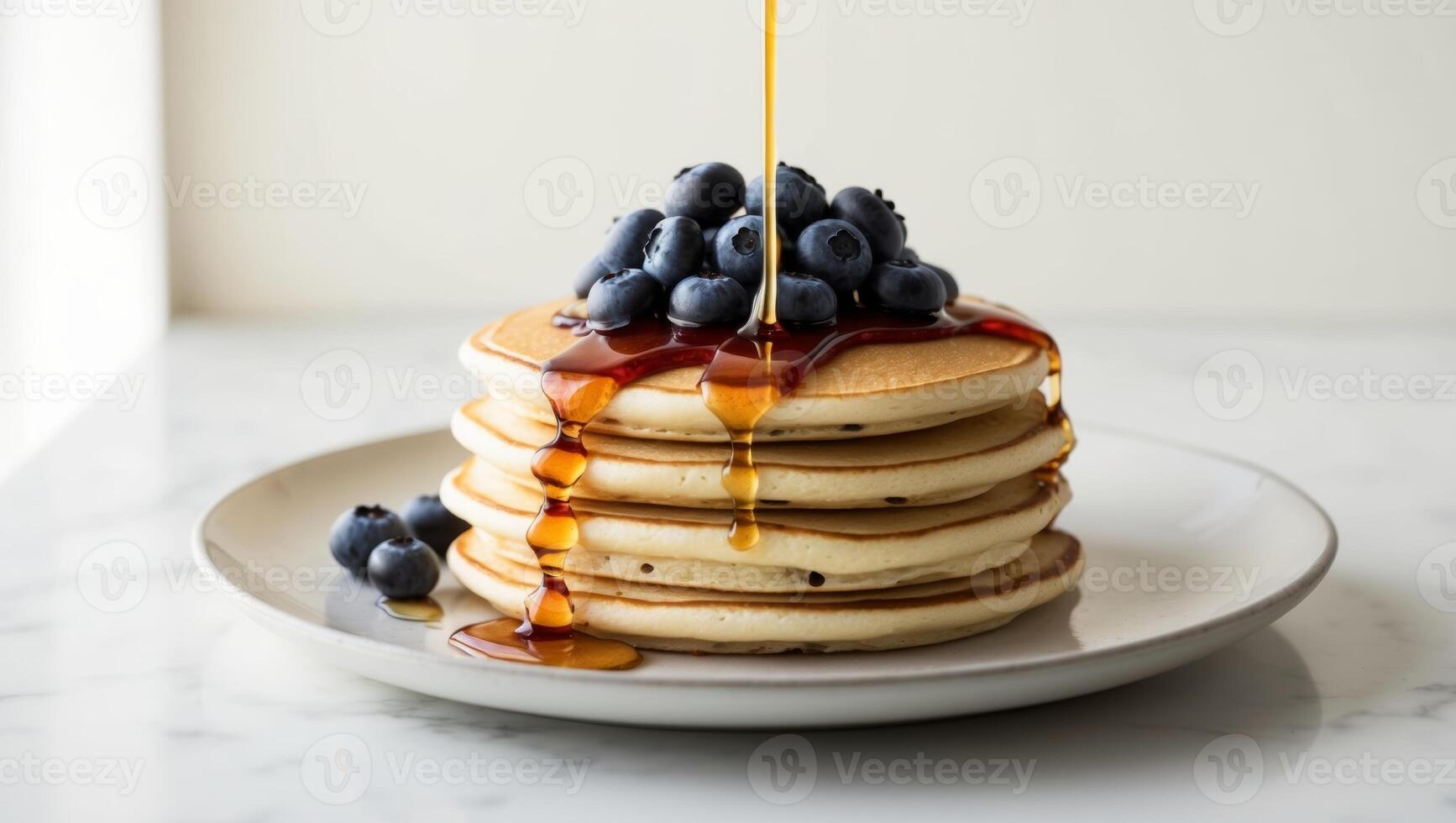 A stack of pancakes with blueberries and syrup photo