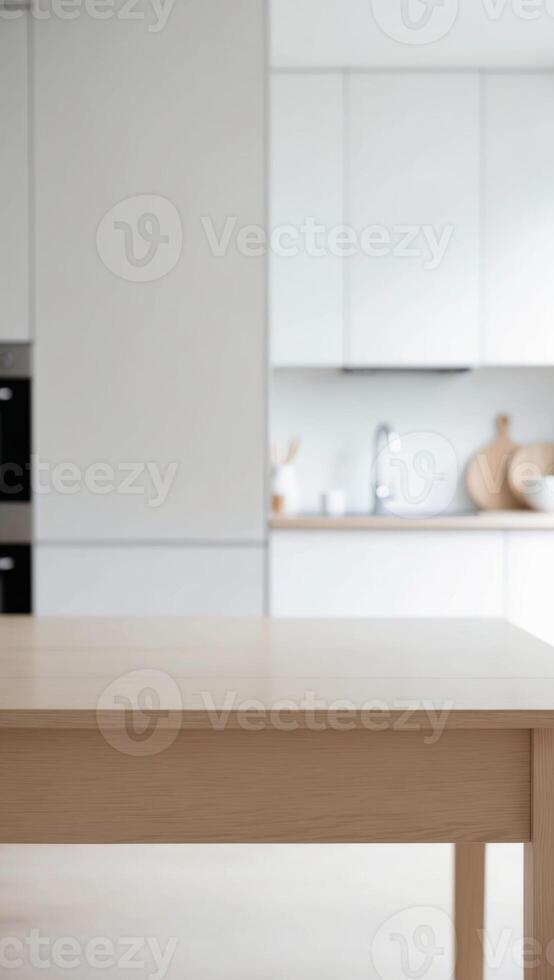 A wooden table in a kitchen with white cabinets photo