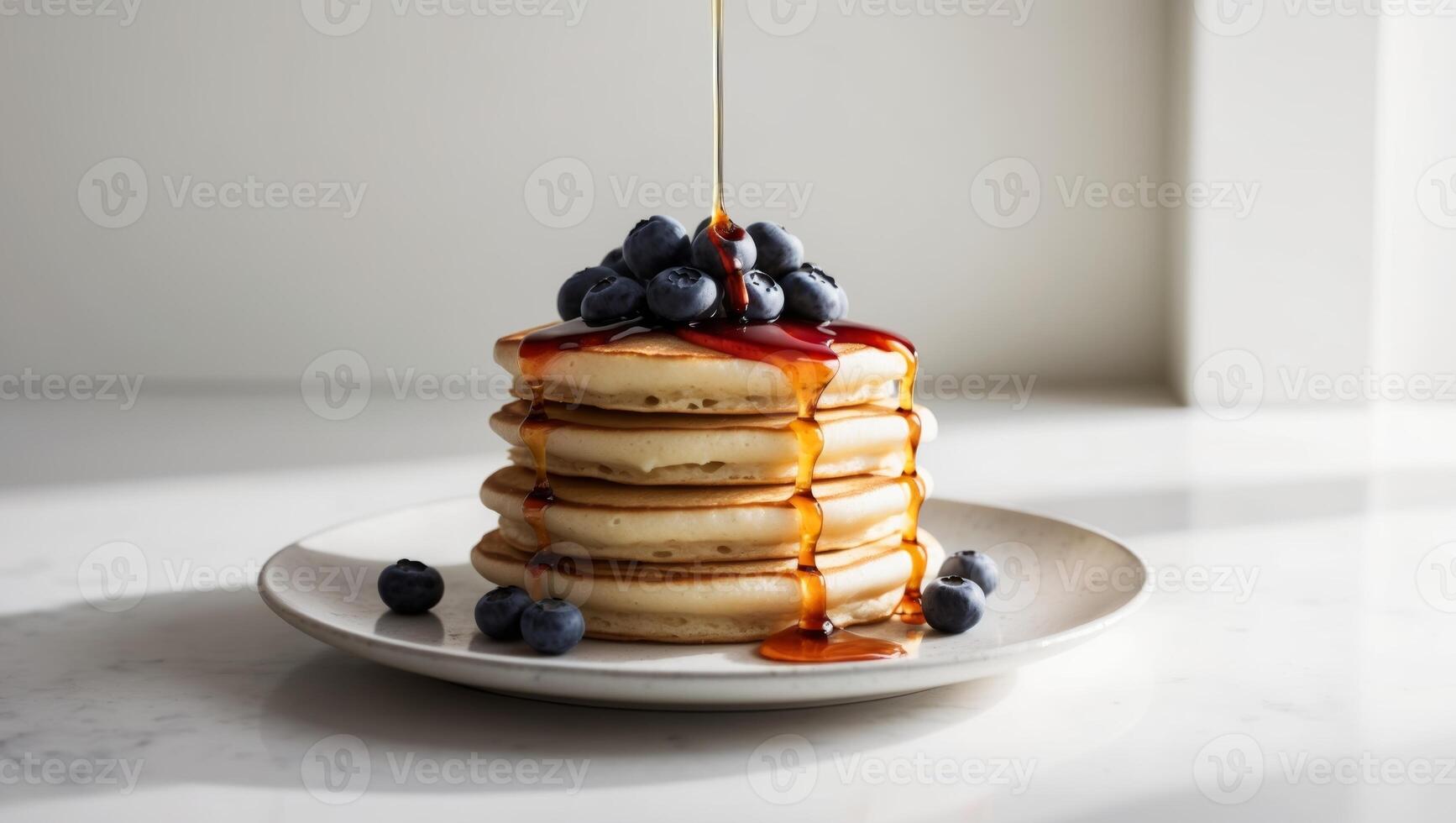 A stack of pancakes with syrup and blueberries photo