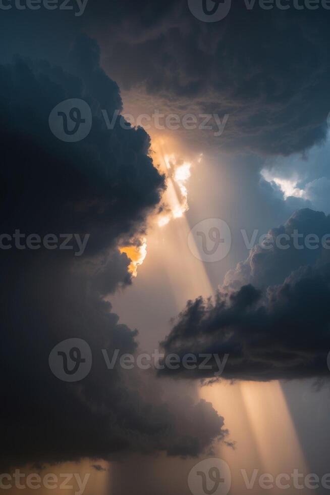 A dark cloud with sun rays shining through it photo