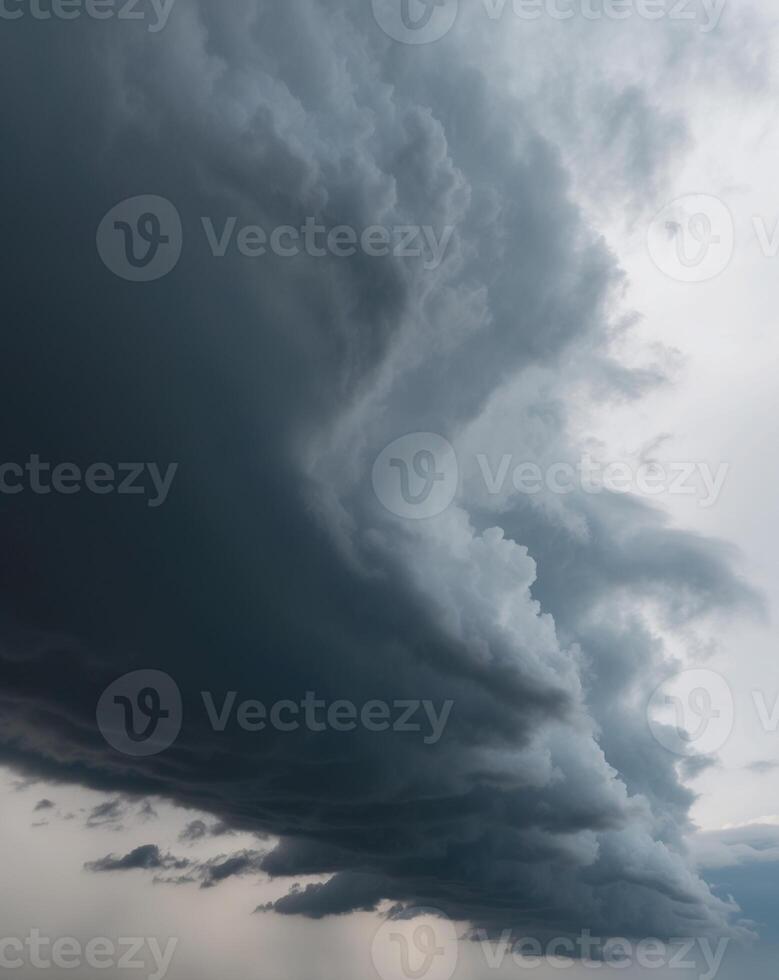 A large storm cloud is seen over a field photo