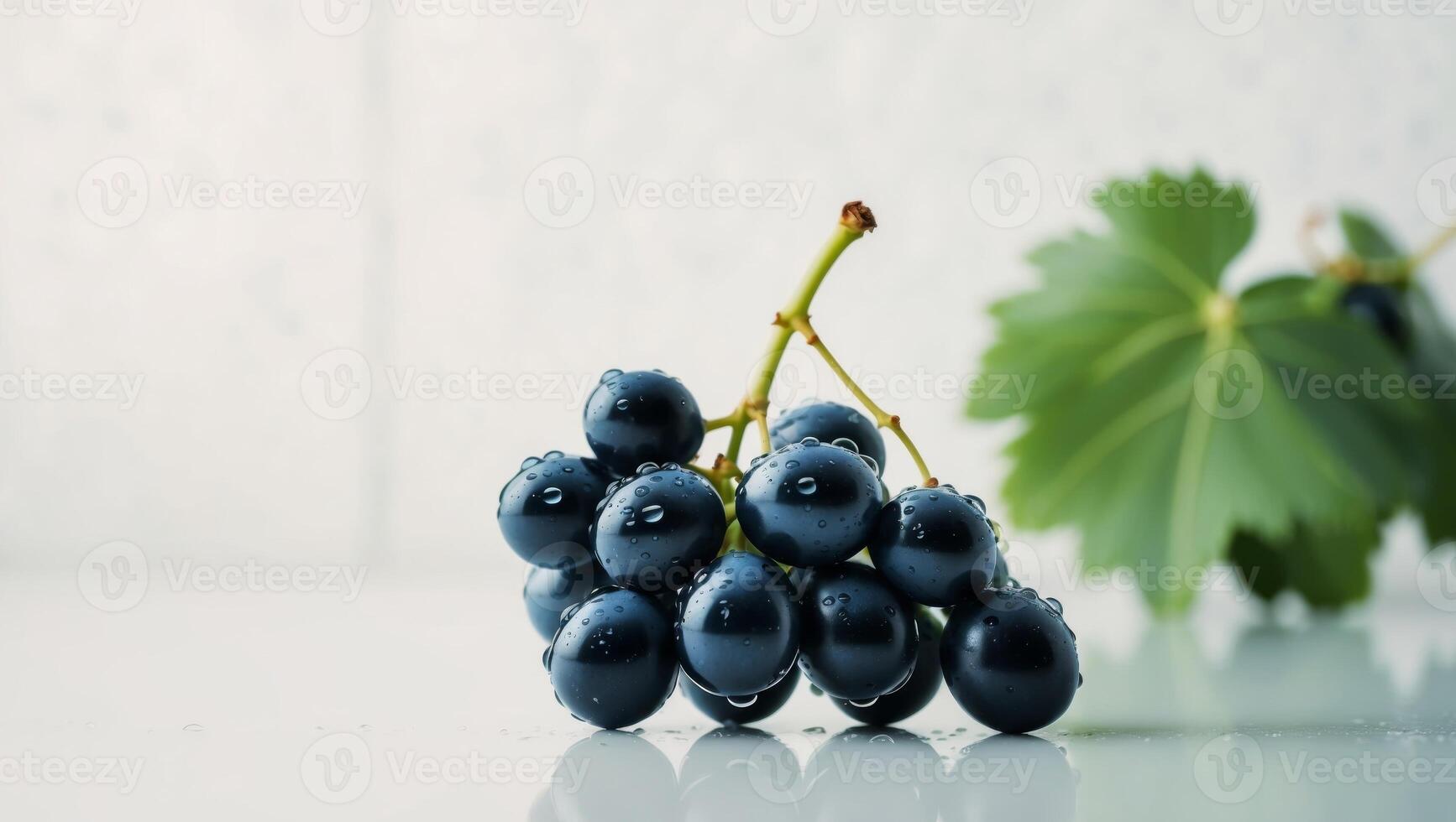 A bunch of grapes on a table with leaves photo