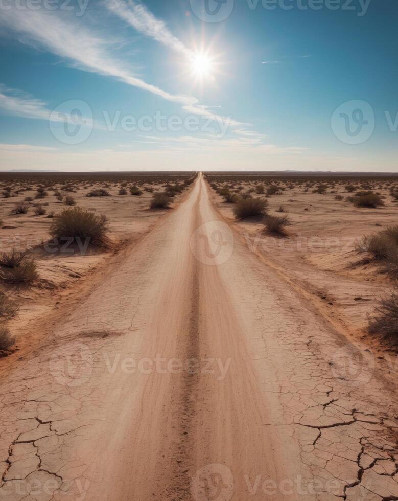 A dirt road in the desert with the sun shining photo