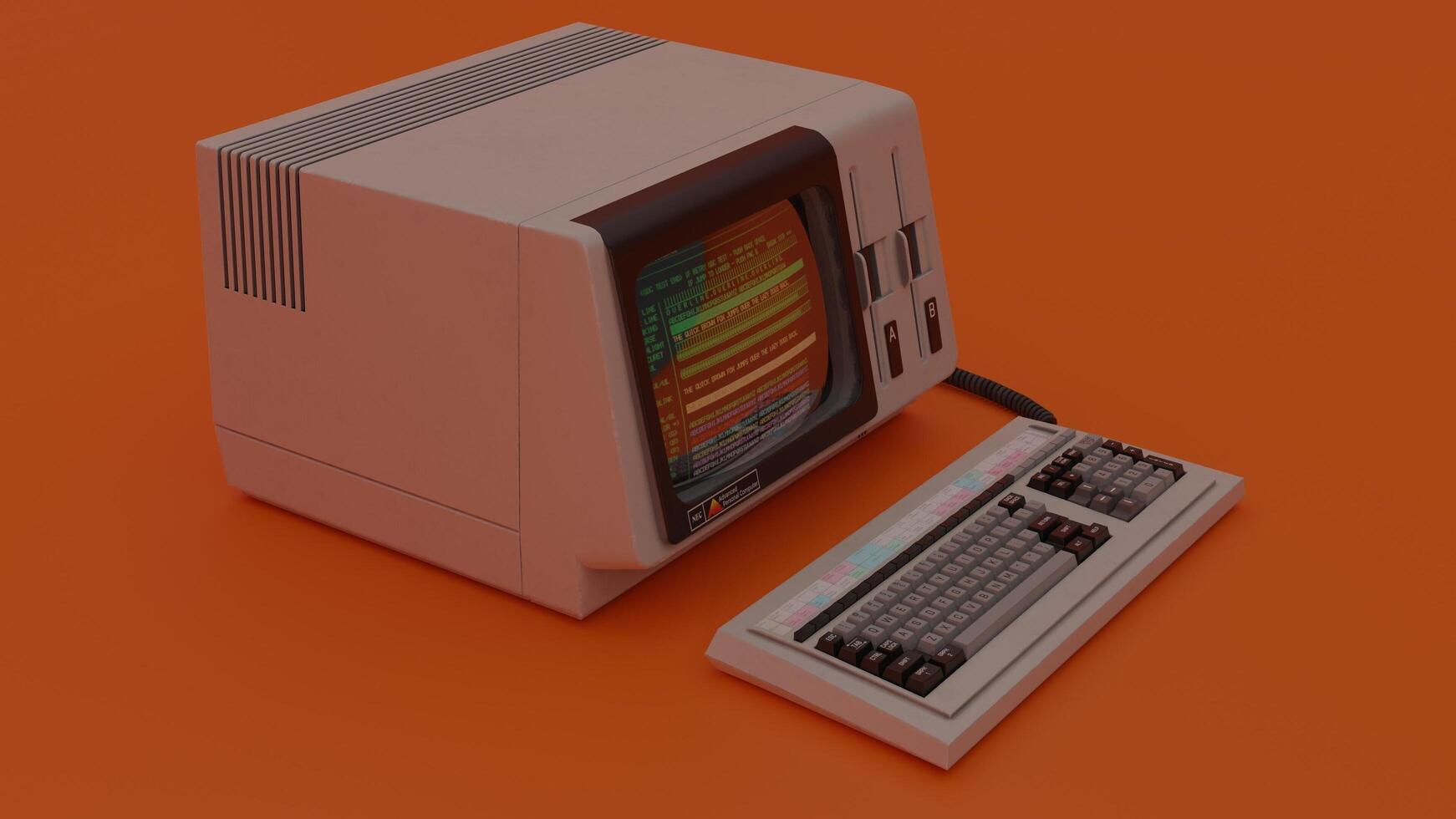 An old computer with a keyboard and mouse on an orange background photo
