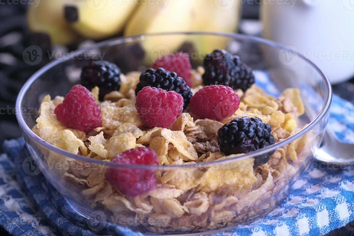 A Delicious Breakfast Cereal Dish Loaded with Fresh Berries, Bananas, and Nutritious Fruits photo