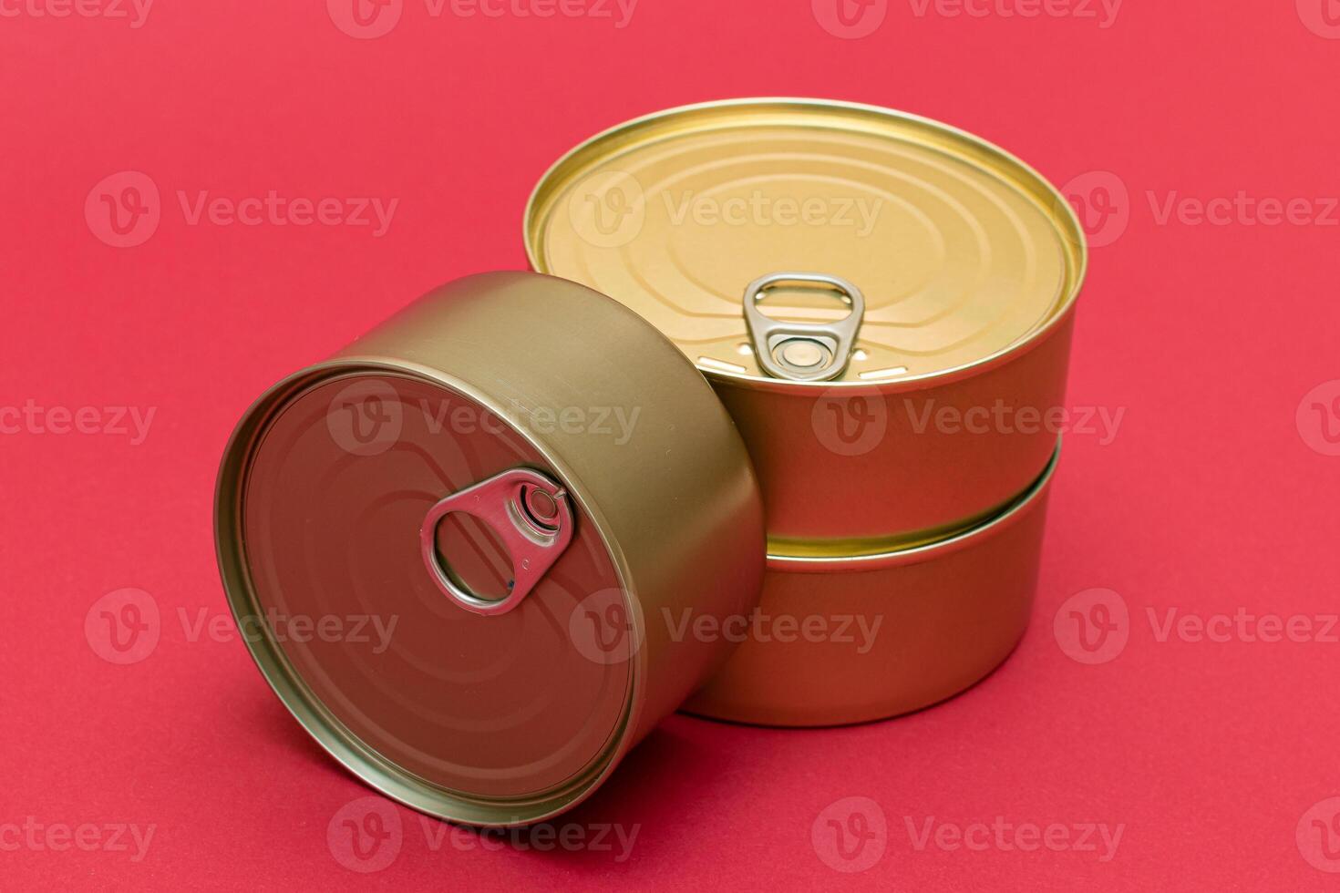 A Group of Stacked Tin Cans with Blank Edges on Red Background. Canned Food. Different Aluminum Cans for Safe and Long Term Storage of Food. Steel Sealed Food Storage Containers photo