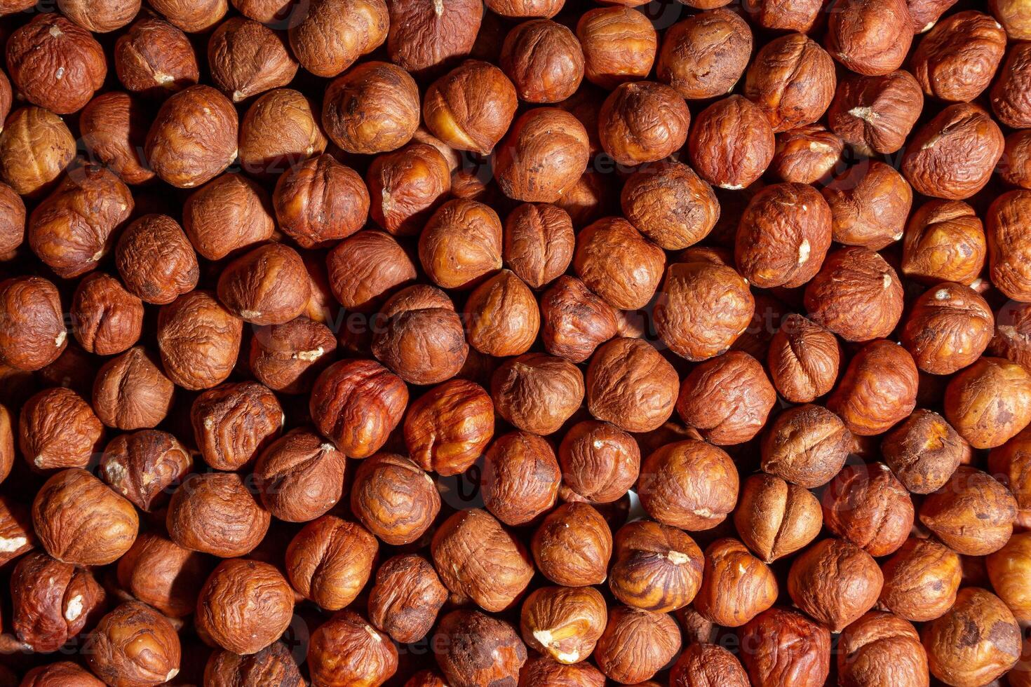 Scattered Peeled Hazelnut - Top View. Background from Hazelnuts. Natural High-Calorie Snacks photo