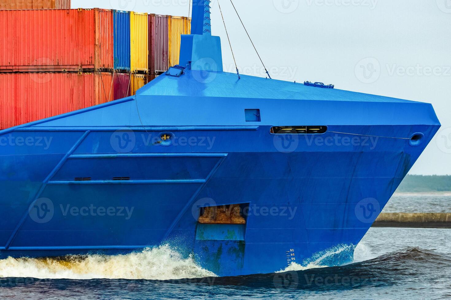 Blue cargo container ship fully loaded underway photo