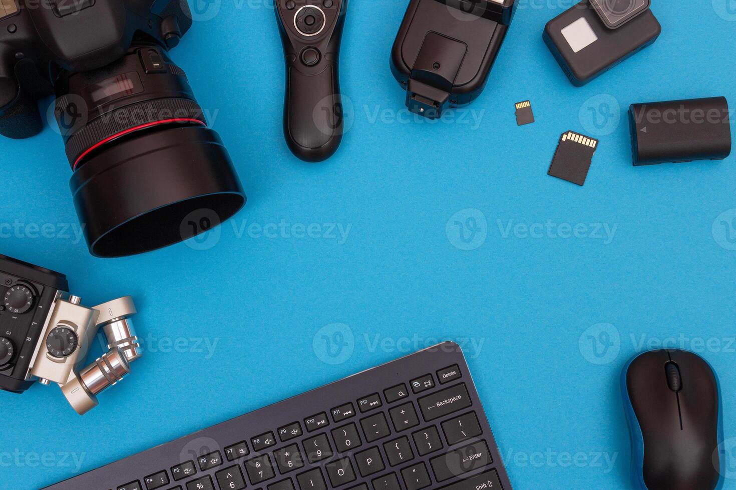 Top View of Photographer's, Videographer's or Blogger's Workplace. Digital Gadgets Lying on Blue Table - Flat Lay photo
