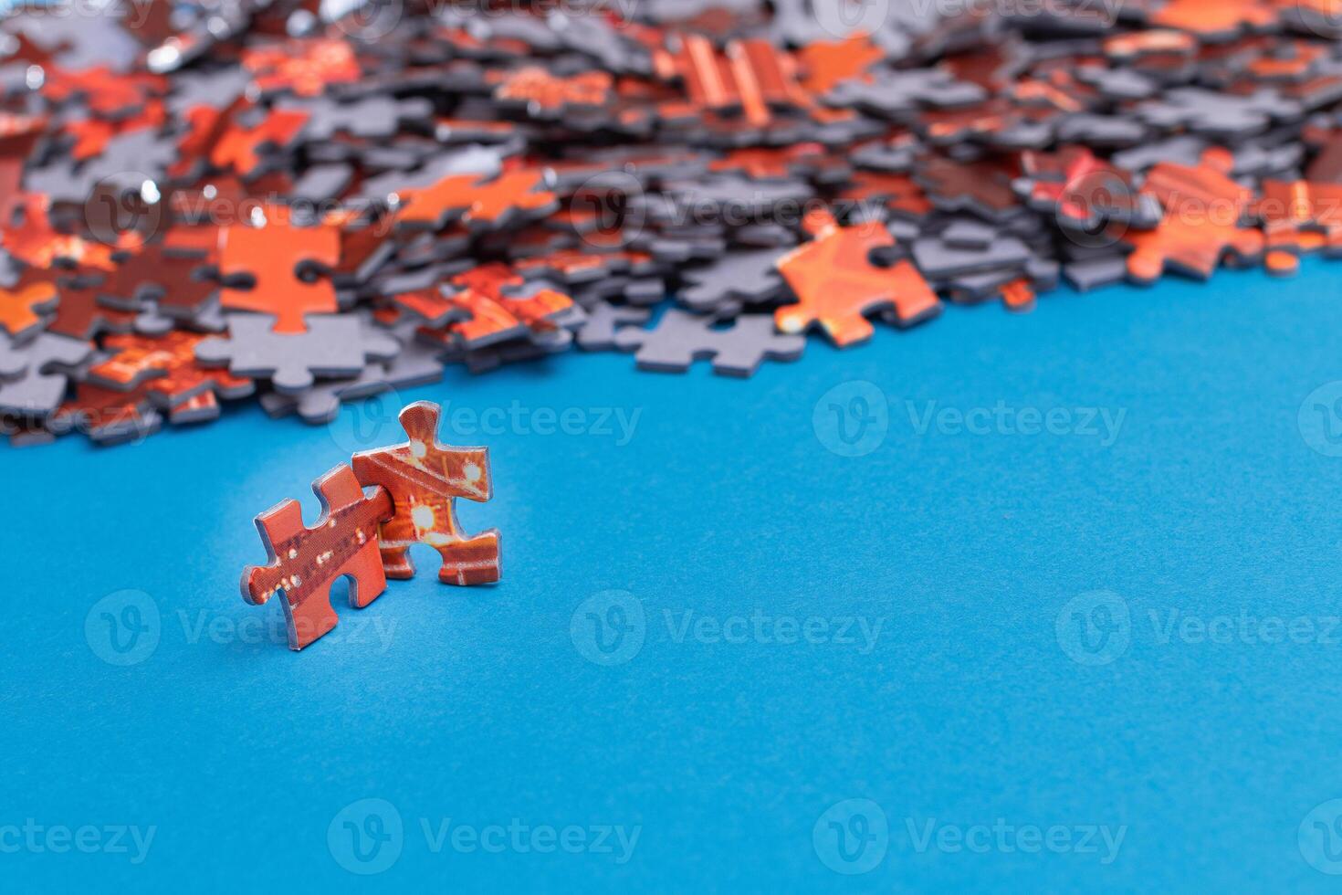 Mixed Pieces of a Colorful Jigsaw Puzzle Lie on the Blue Background With Copy Space - Strategy and Solving Problem Concept photo