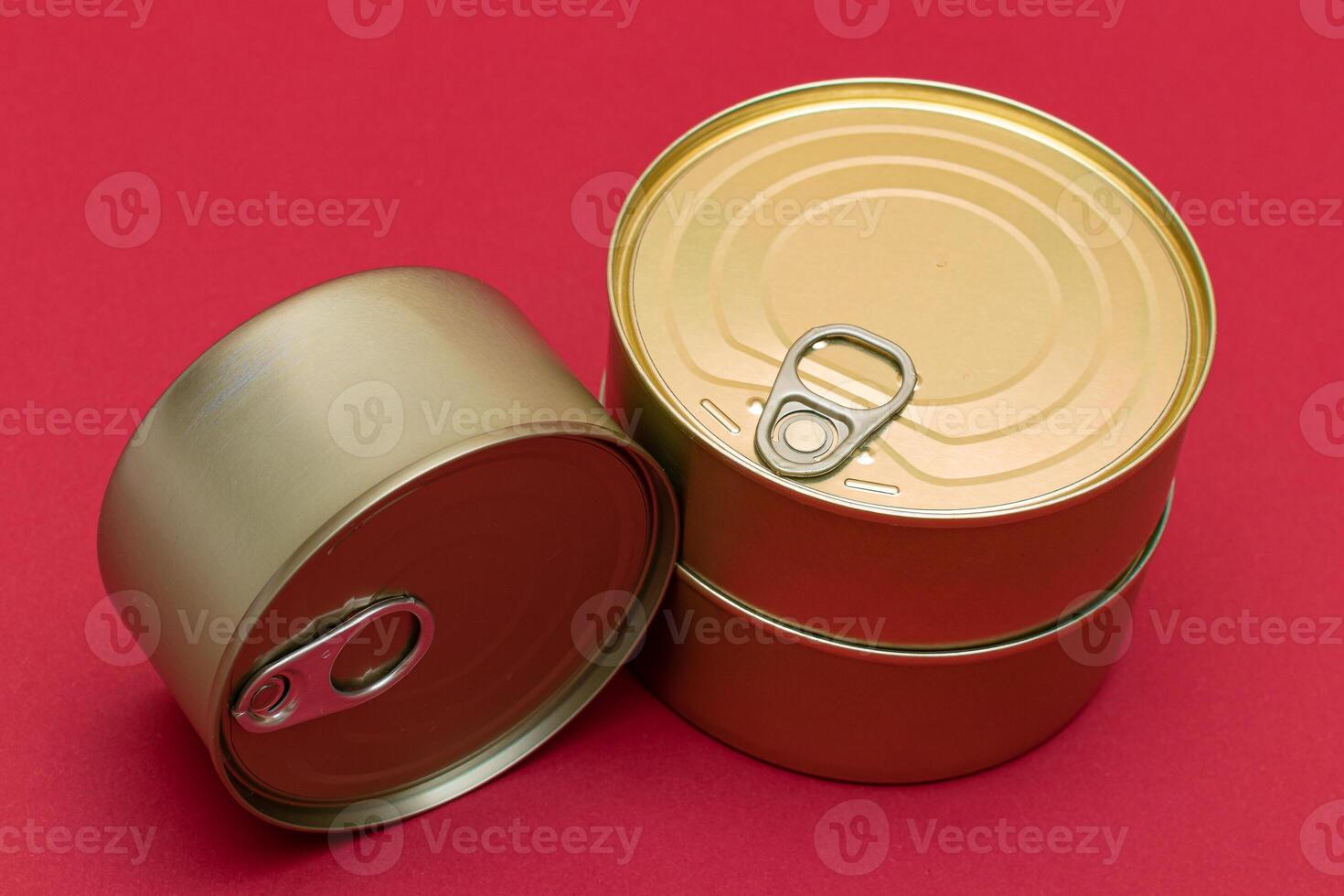 A Group of Stacked Tin Cans with Blank Edges on Red Background. Canned Food. Different Aluminum Cans for Safe and Long Term Storage of Food. Steel Sealed Food Storage Containers photo