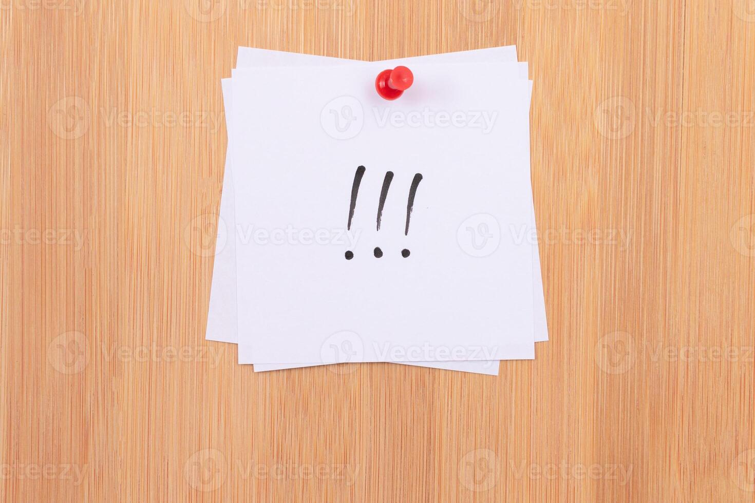 White Sticky Notes with Three Exclamation Points Pinned to the Wooden Message Board. To Do List Reminder in the Office. Memo Note at Work photo