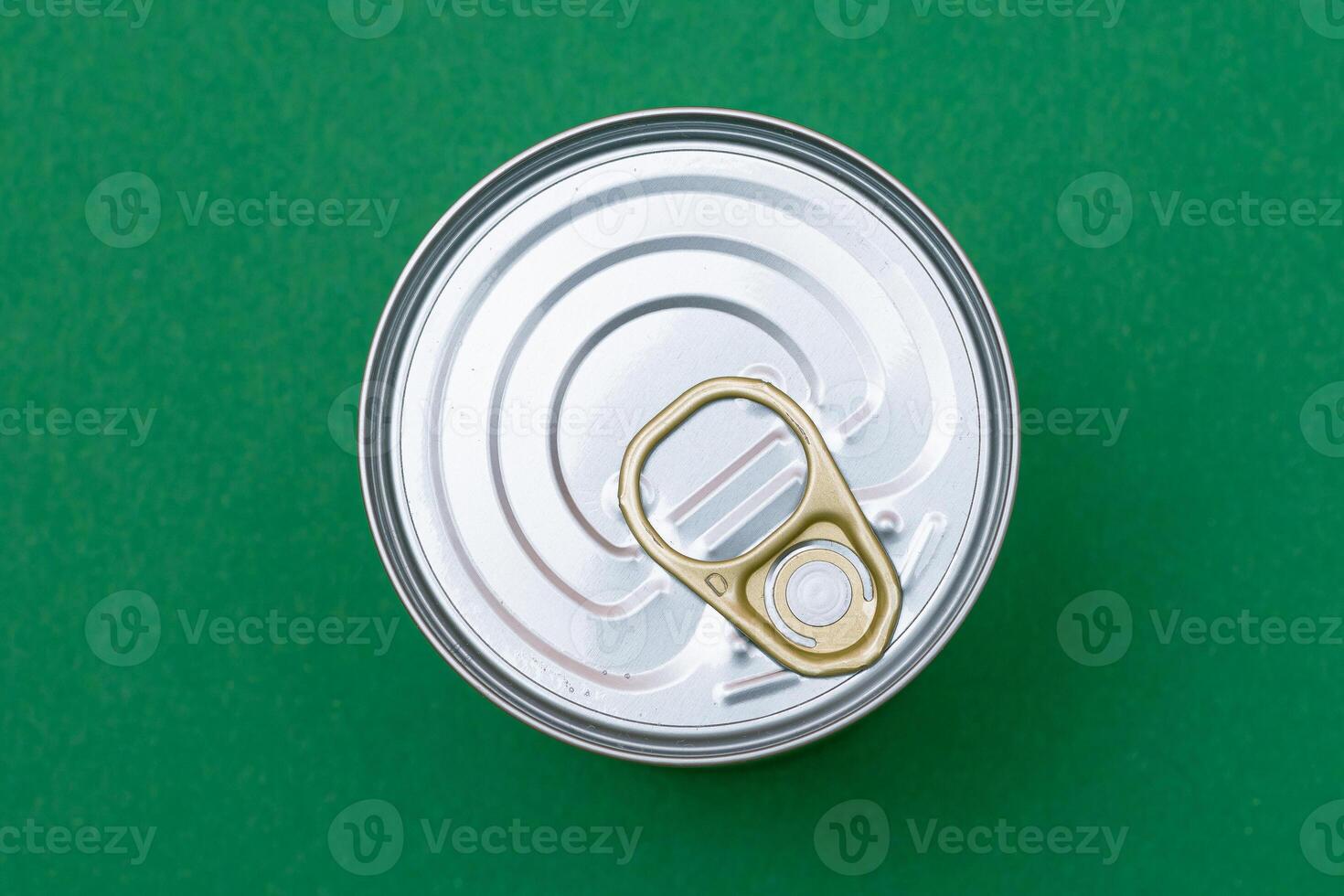 Unopened Tin Can with Blank Edge on Green Background. Canned Food. Aluminum Can for Safe and Long Term Storage of Food. Steel Sealed Food Storage Container photo
