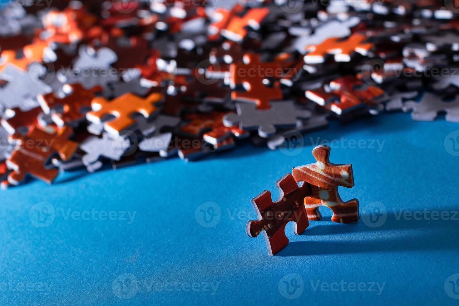 Mixed Pieces of a Colorful Jigsaw Puzzle Lie on the Blue Background - Strategy and Solving Problem Concept photo