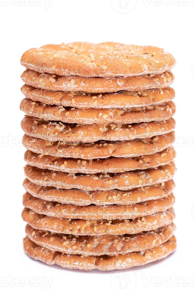 A Stack of Round Salt Crackers with Sesame Isolated on White Background. Dry Snacks - Isolation photo