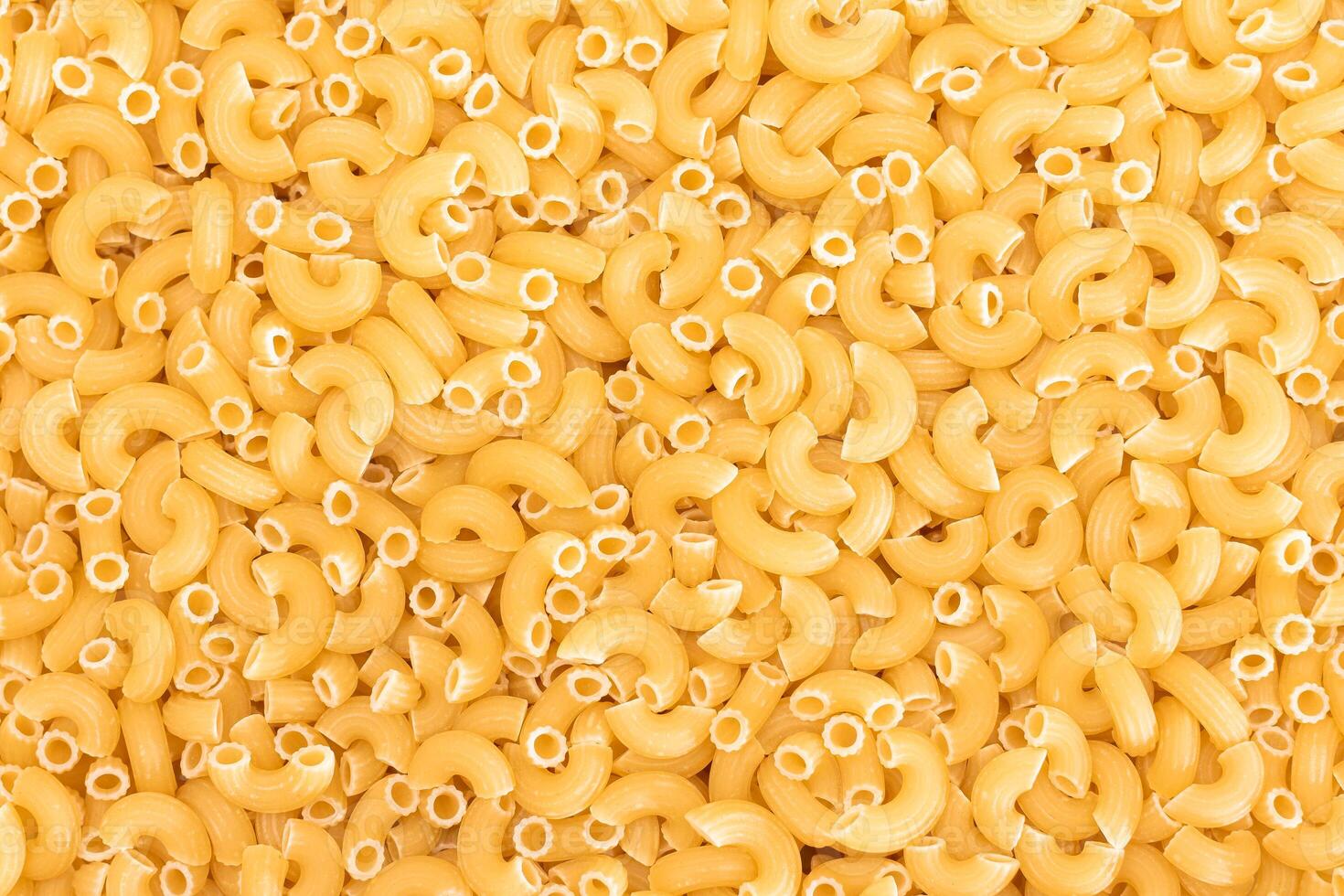 Uncooked Chifferi Rigati Pasta Background. Fat and Unhealthy Food. Classic Dry Macaroni Texture. Italian Culture and Cuisine. Raw Pasta photo